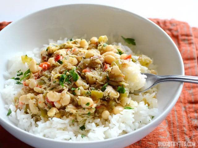 These flavorful Creole White Beans are full of vegetables, Creole spices, and belly filling power. Make a pot on Sunday afternoon and stay full all week. Budetbytes.com Side view of a bowl of Creole White Beans with Chicken