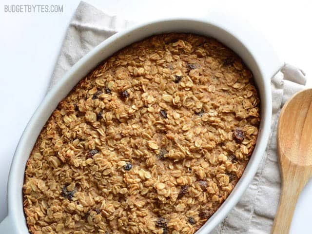 This freezable Oatmeal Cookie Baked Oatmeal tastes like an oatmeal cookie's older, more healthful sibling. Perfect for breakfast meal prep. Budetbytes.com "Oatmeal Cookie Baked Oatmeal finished, in the casserole dish, wooden spoon on the side