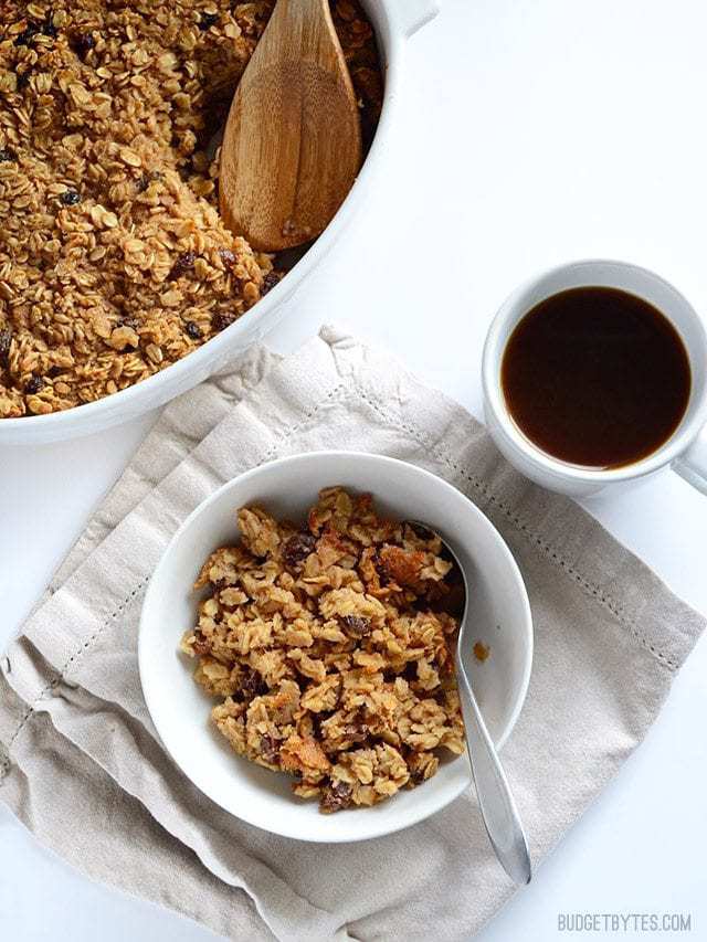 This freezable Oatmeal Cookie Baked Oatmeal tastes like an oatmeal cookie's older, more healthful sibling. Perfect for breakfast meal prep. Budetbytes.com "Oatmeal Cookie" Baked Oatmeal served into a bowl, mug of coffee on the side