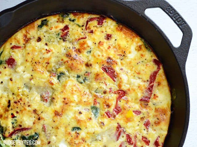 Use leftover ingredients to make a frittata, like this Roasted Red Pepper and Feta Frittata. Great for breakfast, brunch or even dinner! Budetbytes.com Close up of baked Roasted Red Pepper and Feta Frittata
