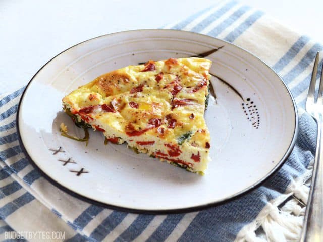 Use leftover ingredients to make a frittata, like this Roasted Red Pepper and Feta Frittata. Great for breakfast, brunch or even dinner! Budetbytes.com One slice of Roasted Red Pepper and Feta Frittata on a plate