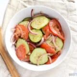A fresh tomato cucumber salad served in a bowl.