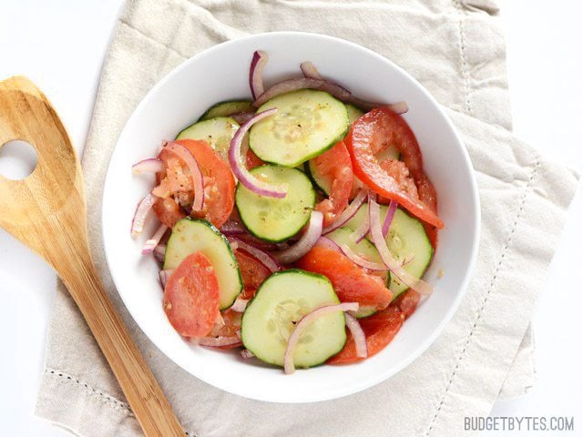 Take advantage of summer's fresh produce with this super Simple Tomato Cucumber Salad. With endless ways to customize, this recipe is a must have. Budetbytes.com Finished Tomato Cucumber Salad