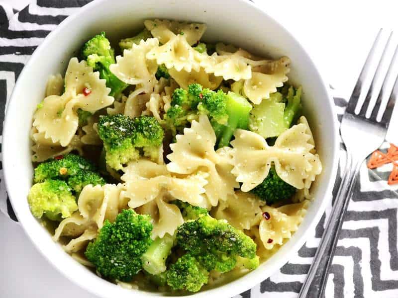 This insanely simple dinner "cheat" is ready in minutes and will keep you full for hours. Bowties and Broccoli is my go-to lazy weeknight dinner. Budetbytes.com Close up overhead view of a bowl full of bowties and broccoli, on a zig zag napkin