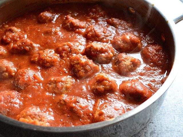 These quick and easy skillet meatballs are made in one skillet with marinara and pack a huge flavor punch. They're my new weeknight dinner favorite! Budgetbytes.com Close up side view of meatballs in the sauce, in the skillet