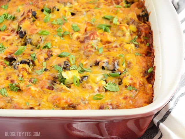 A colorful mix of vegetables, homemade enchilada sauce, corn tortillas, and cheese make this Vegetable Enchilada Casserole an ultimate comfort food. Budetbytes.com Vegetable Enchilada Casserole baked