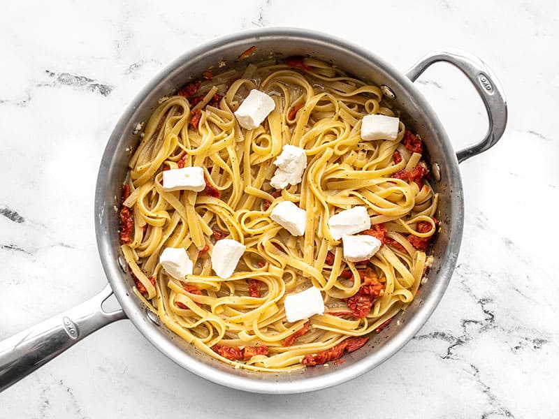 Cream cheese added to the pasta in the skillet