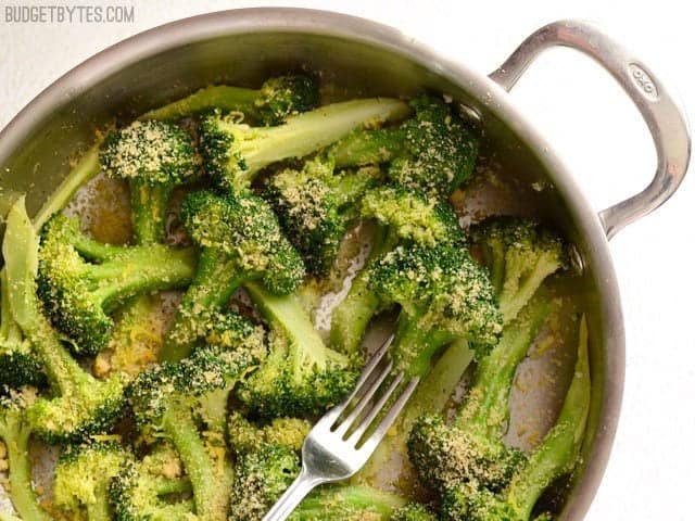 This super fast Garlic Parmesan Broccoli is an easy side dish with versatile flavors that will go with just about any weeknight meal. Budetbytes.com Overhead view of a skillet with Garlic Parmesan Broccoli, a fork in the center