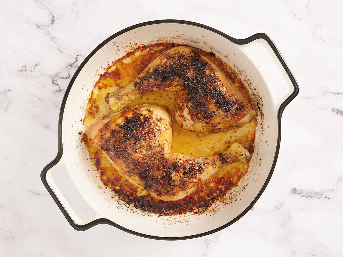 Finished oven roasted chicken legs in a baking dish.