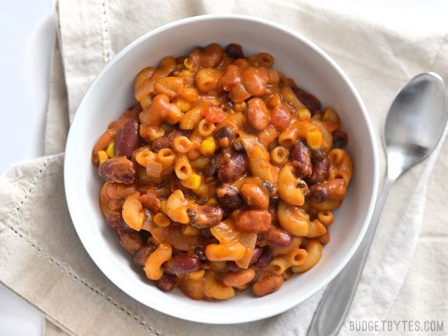 This rich and comforting One Pot Vegetarian Chili Mac and Cheese is the perfect quick and easy weeknight meal. Works great for meal prep! Budetbytes.com Overhead view of a bowl full of vegetarian chili mac and cheese