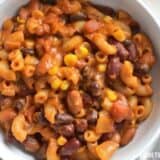 Close-up of cheesy vegetarian chili mac in a bowl.