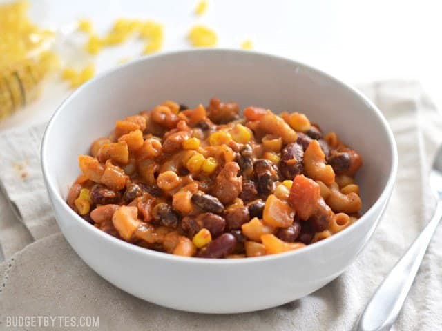 This rich and comforting One Pot Vegetarian Chili Mac and Cheese is the perfect quick and easy weeknight meal. Works great for meal prep! Budetbytes.com Side View of a bowl full of vegetarian chili mac and cheese
