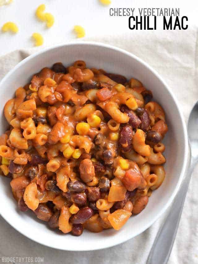 This rich and comforting One Pot Vegetarian Chili Mac and Cheese is the perfect quick and easy weeknight meal. Works great for meal prep! Budetbytes.com Close up overhead view of a bowl full of vegetarian chili mac with the title text in the top right corner.