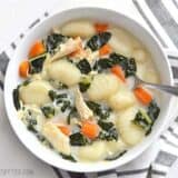 Kale chicken gnocchi soup served in a bowl.