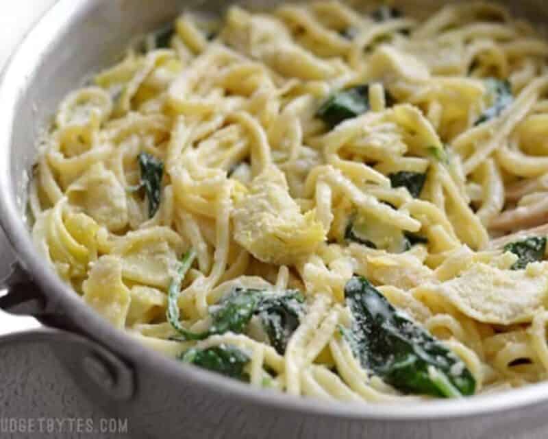 Pot of creamy spinach artichoke pasta.