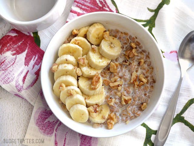 Oatmeal isn't the only grain that is great for breakfast! Take leftover cooked farro and turn it into this delicious Banana Nut Breakfast Farro bowl. Budetbytes.com A bowl of Banana Nut Breakfast Farro with banana and walnuts, ready to be eaten