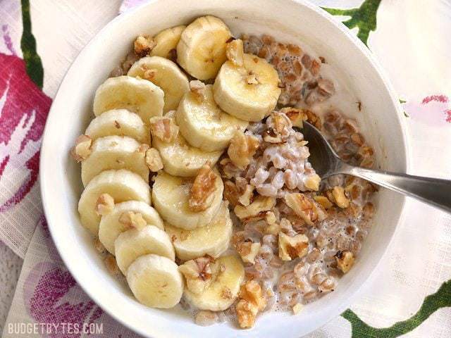 Banana nut breakfast farro served in a bowl with a spoon.