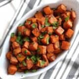 Chili roasted sweet potatoes arranged on a plate.