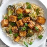 Pan-fried sesame tofu with broccoli in a bowl.