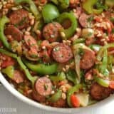 Smoked sausage, peppers, and farro in a skillet.