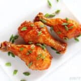 Crispy baked honey Sriracha chicken drumsticks.