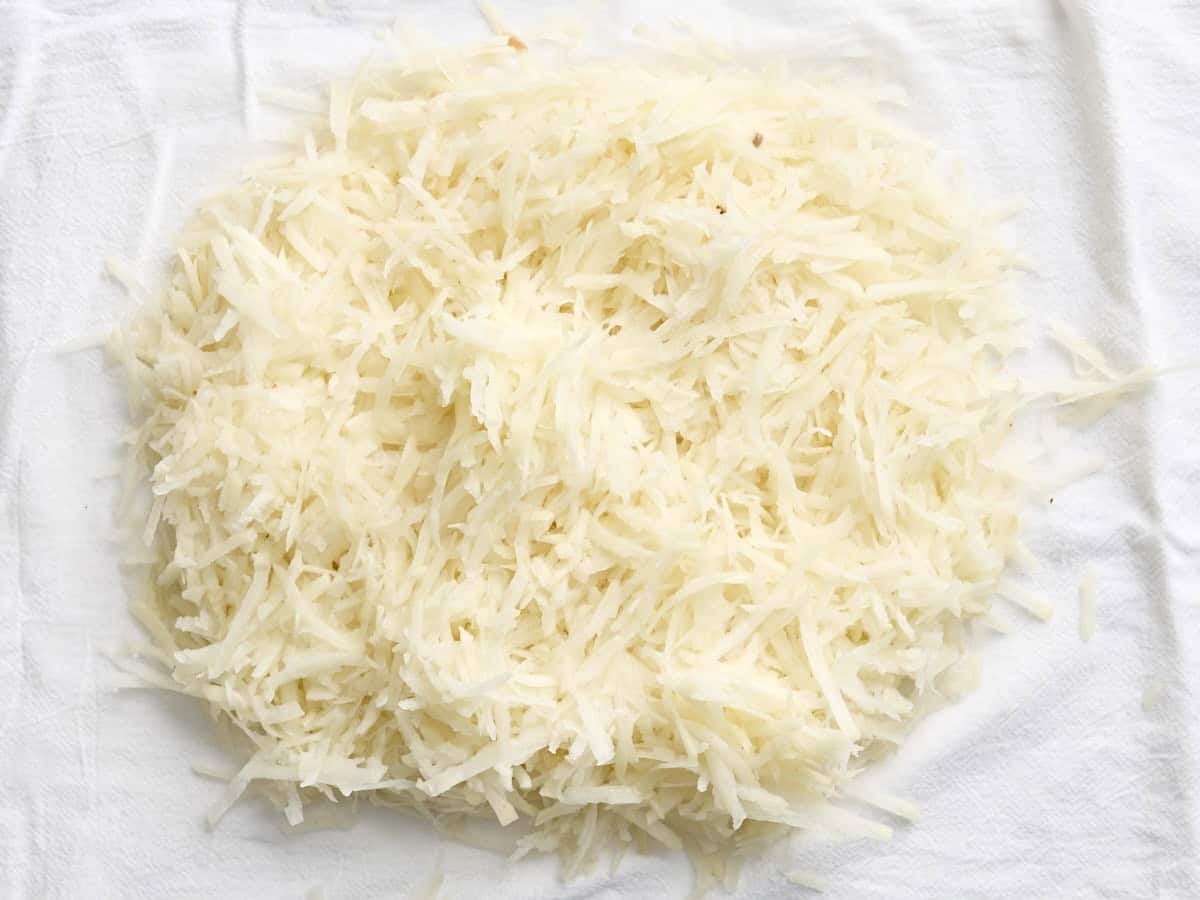 Shredded potatoes on a kitchen towel.