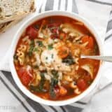 Garden vegetable lasagna soup served with a spoon.