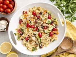 Overhead view of a homemade Greek chicken pasta salad on a platter.