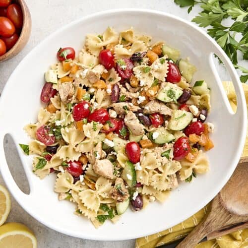 Overhead view of a homemade Greek chicken pasta salad on a platter.