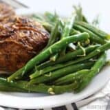 Lemon butter green beans served in a plate.
