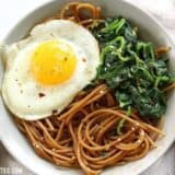 Sesame noodles with wilted greens and fried egg.