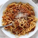 Sunday slow cooker beef ragu served in a bowl with a fork.