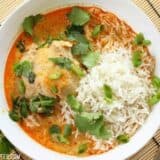 Thai coconut curry braised chicken thighs in a dish.