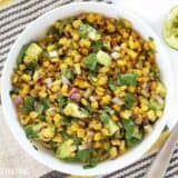 Warm corn and avocado salad served in a bowl.
