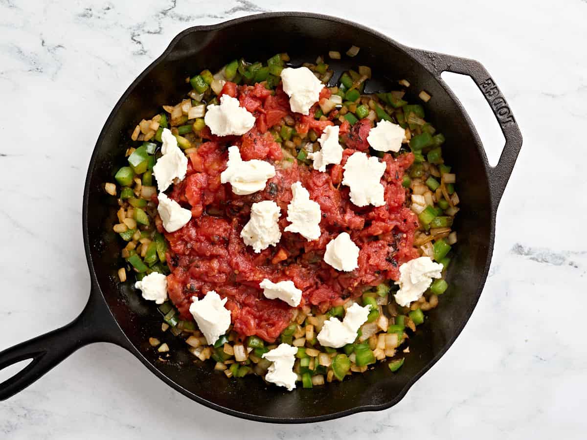 Cream cheese and diced tomatoes added to sauteed onions and green bell pepper.
