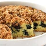 Open blueberry buttermilk coffee cake on a serving plate.