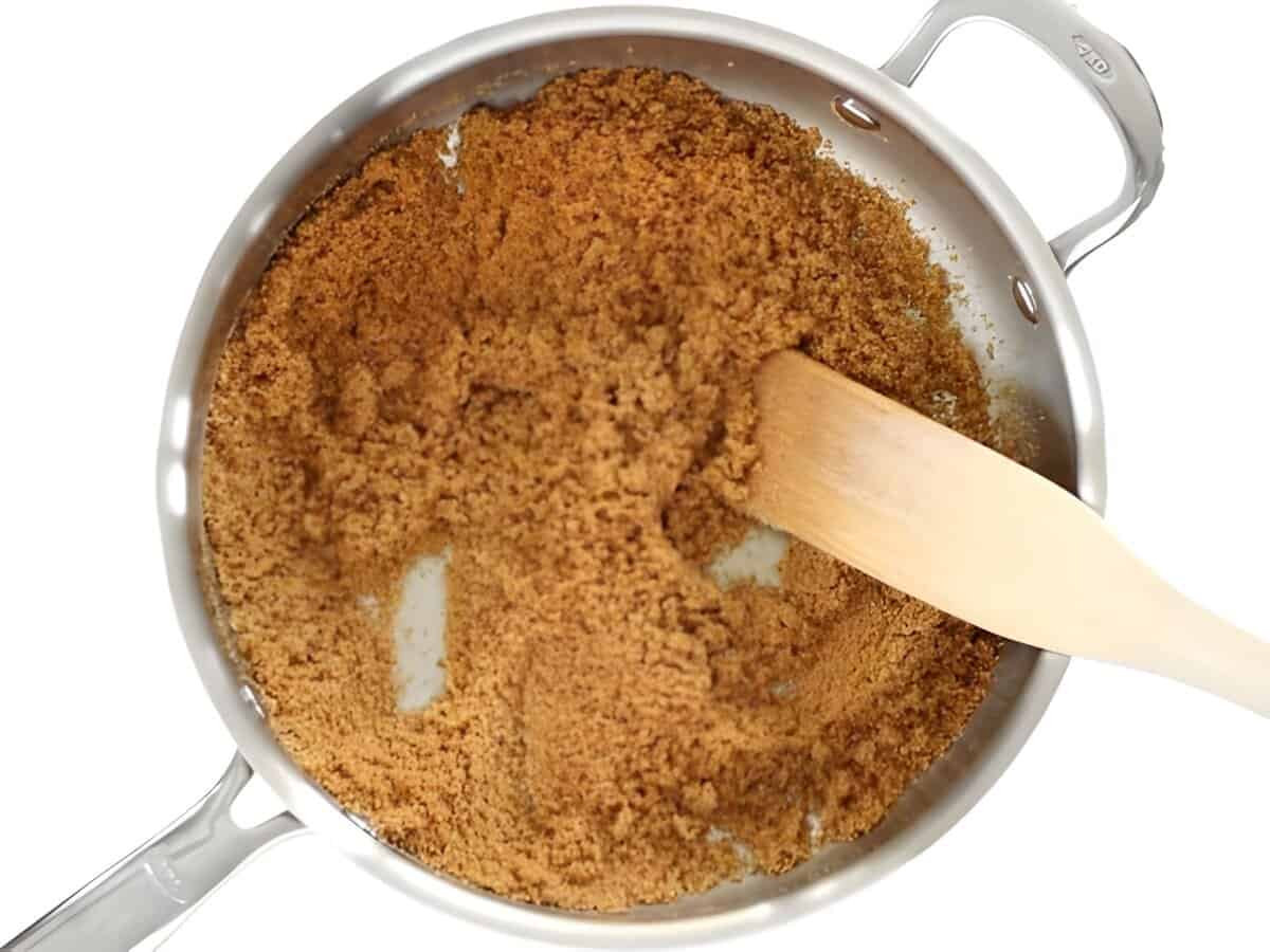 Toasted breadcrumbs in a skillet with a spatula.
