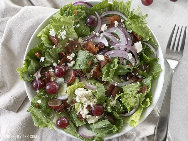 Top view of a plate of Grape Feta and Bacon Salad with a fork on the side