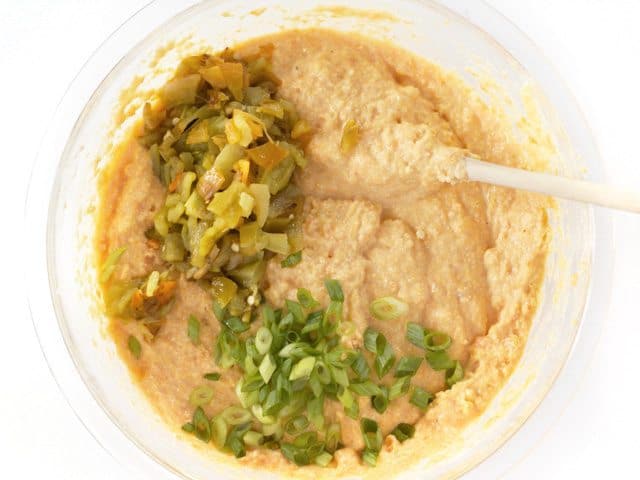 Chopped Hatch Chiles and onion added to cornbread mixture in bowl