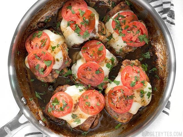 A simple marinade, creamy mozzarella, and fresh tomatoes turn simple chicken thighs into a fast and easy weeknight dinner in this Balsamic Chicken Skillet. BudgetBytes.com Overhead view of the finished Balsamic Chicken Skillet