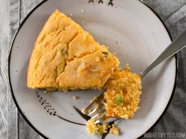 Slice of Hatch Chile Sweet Potato Cornbread on a plate with a fork