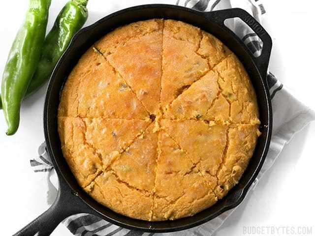 Top view of sliced Hatch Chile Sweet Potato Cornbread in cast iron skillet