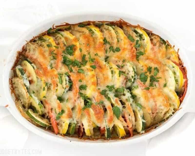 Baked vegetable tian garnished with parsley.
