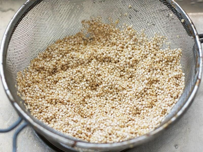 Rinse Quinoa in wire mesh sieve