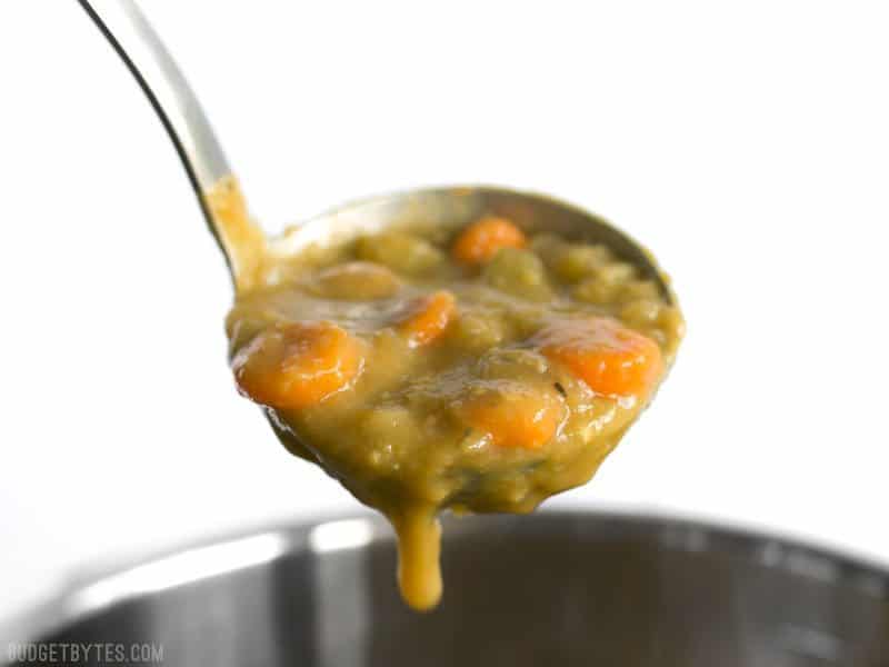 The pressure cooker gives this homemade split pea soup that all-day simmered flavor in a fraction of the time. Delicious, filling, inexpensive, and FAST! BudgetBytes.com A ladle full of Pressure Cooker Split Pea Soup dripping into the pot.