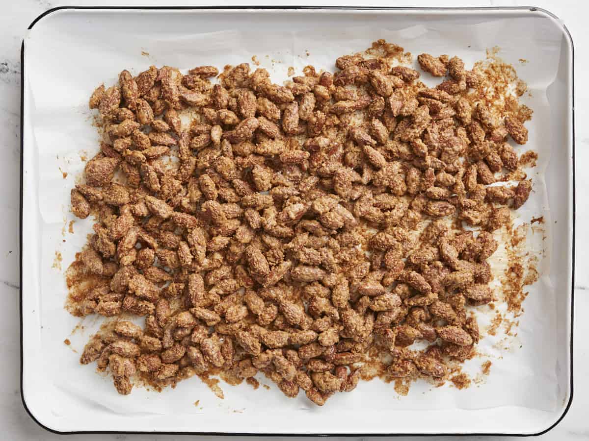 Homemade Candied Almonds are a fraction of the price of store bought and make great homemade gifts for the holidays! BudgetBytes.com Baked candied almonds on the baking sheet.