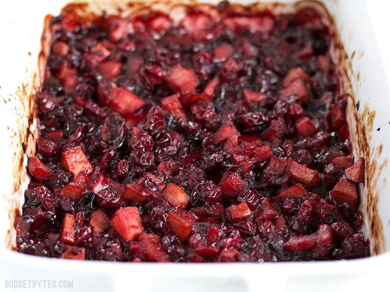 Roasted Apple Cranberry Relish is a thick, jam-like condiment whose uses go far beyond the Thanksgiving table. BudgetBytes.com Close up of Roasted Apple Cranberry Relish in the casserole dish, viewed from the front.