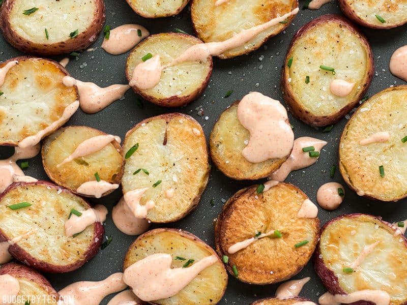 Close up of Salt & Vinegar Roasted Potatoes with sauce drizzled over the top