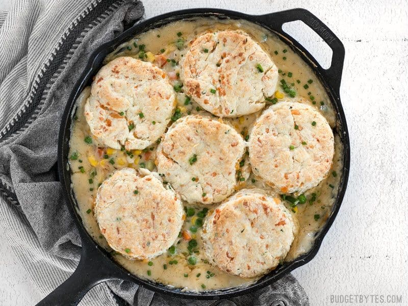 This rich and comforting Vegetable Pot Pie Skillet is made fast and easy for weeknight dinners thanks to frozen vegetables. Comfort food all in one skillet! Budgetbytes.com Finished baked Vegetable Pot Pie Skillet with Cheddar Biscuit Topping
