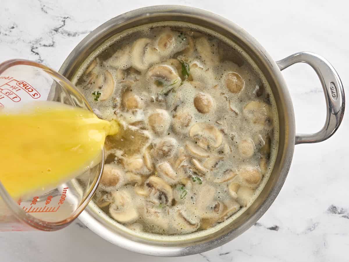 Egg being added to egg drop soup.